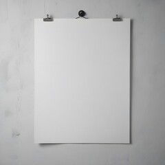Blank white poster hanging on a wall with two metal clips