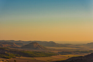 a valley surrounded by mountains with beautiful morning light, creating a serene and picturesque...