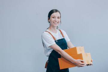 Smiling Asian woman in casual clothes holding a cardboard box mockup while standing against an isolated white background. shipping business concept