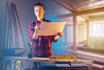 Woman carpenter. Girl builds house with her own hands. Lady foreman with paper plan. Woman...