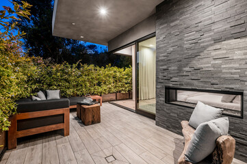 a view of the patio in front of a brick wall and wood paneling