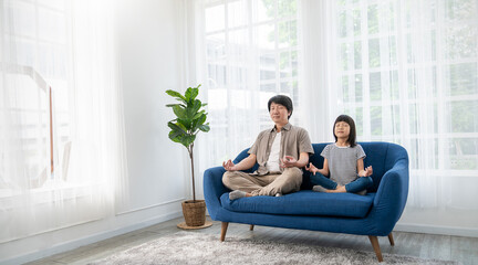 Portrait of young asian father daughter prepare for relax post in yoga meditation. Das little girl...