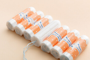 Tampons on a beige background. Feminine hygiene products. Period. Menstrual cycle, pad. Top view....