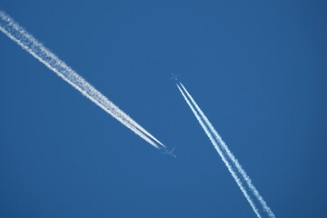 two planes in the sky, two parallel airplane tracks in the blue sky, contrails