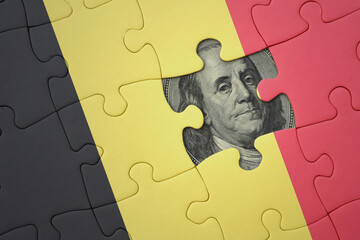 puzzle with the national flag of belgium and usa dollar banknote. finance concept