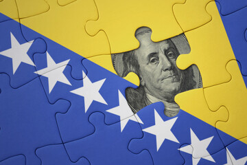 puzzle with the national flag of bosnia and herzegovina and usa dollar banknote. finance concept