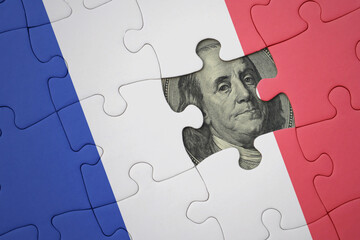 puzzle with the national flag of france and usa dollar banknote. finance concept