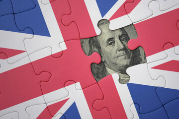 puzzle with the national flag of great britain and usa dollar banknote. finance concept