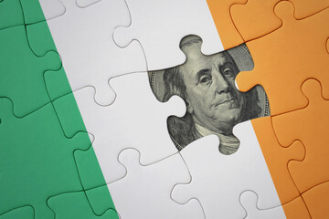 puzzle with the national flag of ireland and usa dollar banknote. finance concept