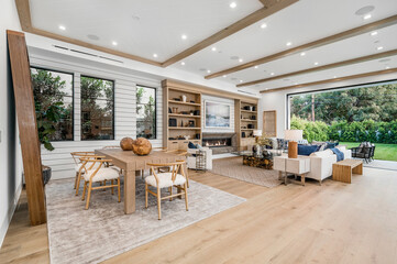 a large living room area with white walls and wooden ceiling
