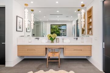 a large modern bathroom with two sinks, an vanity and two mirrors