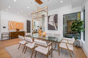 an eclectic home with modern style features glass tables and chairs in the room