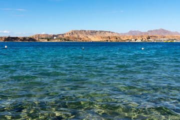 Sharm El-Sheikh, Egypt: blue water of Red sea beach coastal mountain view.