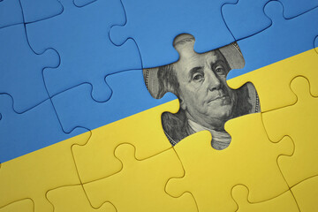puzzle with the national flag of ukraine and usa dollar banknote. finance concept