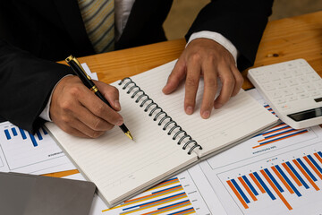 Businessman analyzing company financial report, balance sheet, working with document graphs Save photos for the stock market, office, taxes, close-up photos.