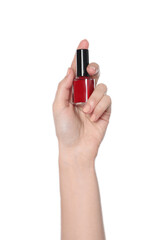 Woman holding nail polish on white background, closeup