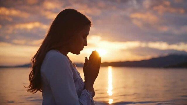 Girl Folded Hands in Prayer at Sunset, Slow Motion Video. Seeking Forgiveness and Repentance, Praying to God with Deep Reverence
