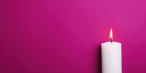 Magenta background with white thin wax candle with a small lit flame for funeral grief death dead sad emotion with copy space texture for display 
