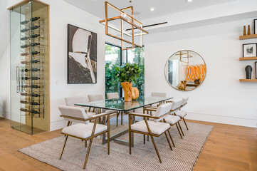 a room with some glass tables and chairs on a rug