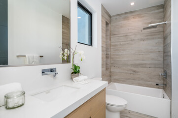 a clean bathroom is displayed with an elegant design and modern bathtub