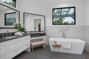 this is a large modern bathroom with glass windows and a white tub