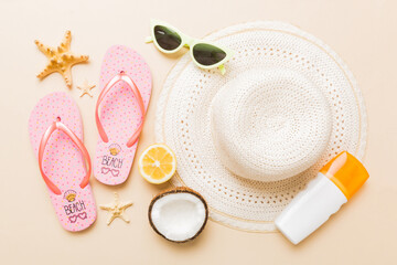 Top view of various seashells placed near colorful fruit and stylish summer accessories on table...
