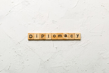 diplomacy word written on wood block. diplomacy text on cement table for your desing, concept