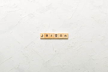 Jargon word written on wood block. Jargon text on cement table for your desing, Top view concept