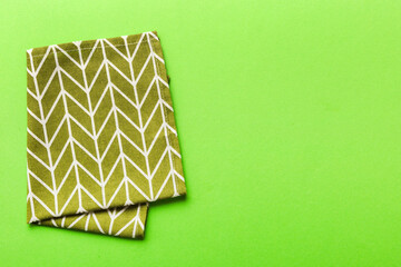 top view with green kitchen napkin isolated on table background. Folded cloth for mockup with copy...