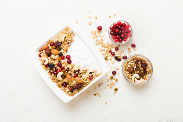 Healthy breakfast food with granola, yogurt, fruits and nuts. Dessert parfait with dried fruits for...