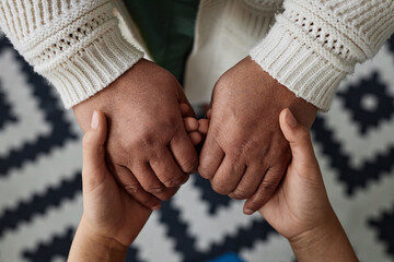 Top view closeup of Black senior woman holding hands with little girl, generations and heritage concept