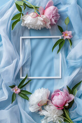 Elegant White Picture Frame Surrounded by Pink and White Peonies on Blue Fabric. invitation card