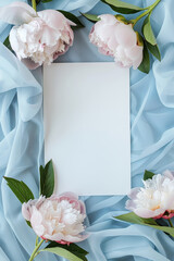 Beautiful White Invitation Card with Peonies and Soft Blue Drapery Background with copy space