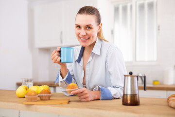 Positive woman having breakfast, drinking coffee - 807009669