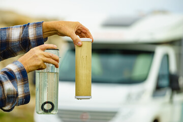 Person showing aqua filter cartridge used in caravan.