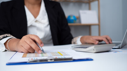 Fototapeta premium Business woman people use computers and paper documents to analyze business and manage corporate information. Business analysis with charts, indicators, and KPIs to improve organizational performance.