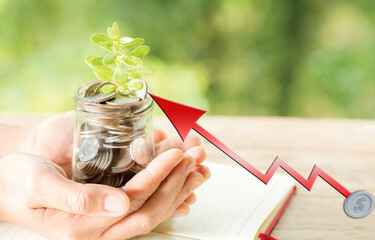 Businessman, Investor, Trader, Analyst, or Stock market points finger at stacked coins for interest...