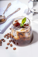 Coffee Jelly Dessert made with strong espresso coffee, gelatin or agar and whipped cream. Asian cold coffee sweets kohii zerii kanten on white table background copy space