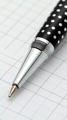 Elegant black and white polka dot pen on graph paper