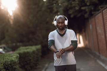 Man with headphones resting after street run