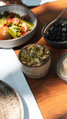 Delicious rich Traditional Turkish breakfast include tomatoes, cucumbers, cheese, butter, eggs, honey, bread, bagels, olives and tea cups. Ramadan Suhoor