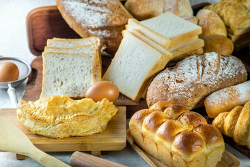 An assortment of breads and pastries on a wooden table.