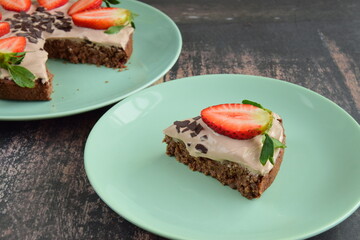 Strawberry oatmeal chocolate cake top with yogurt, shaved chocolate and fresh strawberry