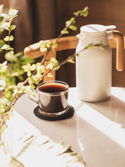 morning coffee, thermos, white table, window, Nordic Scandinavian interior