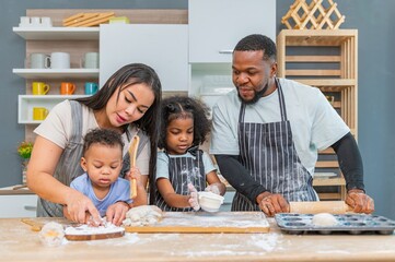 african afro black daughter kids with dad father and mom happy family funny for teach cooking. Black african daughter afro hair and son enjoy with dad preparing the dough, bake cookies in the kitchen