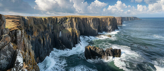 A breathtaking view of a rugged coastline, with cliffs plunging into the sea and waves crashing...