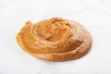peanut butter on white marble background