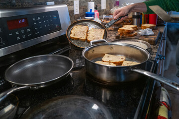 Man cooking french toast at home in his kitchen
