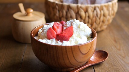 Curd bowl adorned with fresh strawberries Explore creamy texture of homemade curd mixed with strawberries Indulge in simplicity of curd paired with luscious strawberries delightful treat for everyone