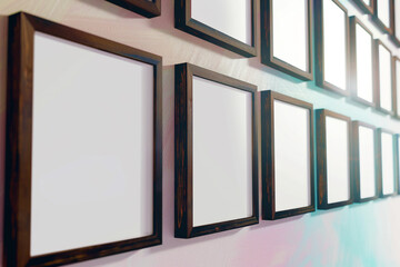 a elegant arrangement of slender, dark wooden frames, each featuring a vivid white emptiness, on a wall painted in a soft pastel hue exhibit